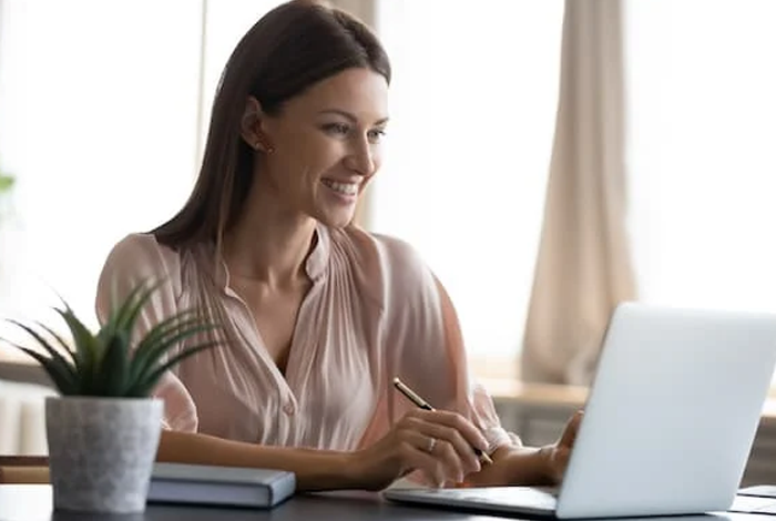 a woman typing on a laptop